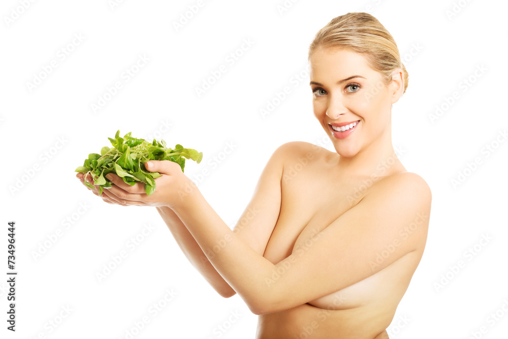 Portrait of happy nude woman holding lettuce Portrait of happy nude woman holding lettuce