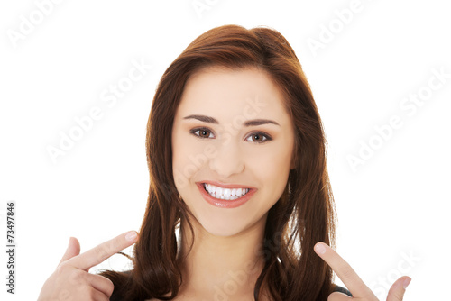 Young woman showing her teeth