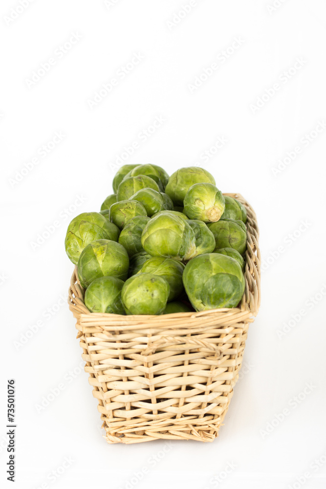 Basket full of brussel sprouts isolated on white Basket full of brussel sprouts isolated on white