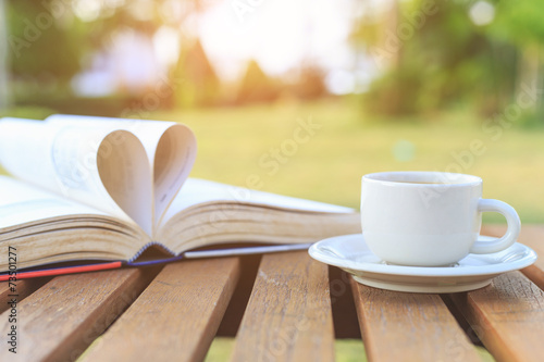 Coffee cup and book on the table in the morning