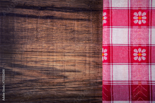 Top view of checkered napkin on empty wooden table
