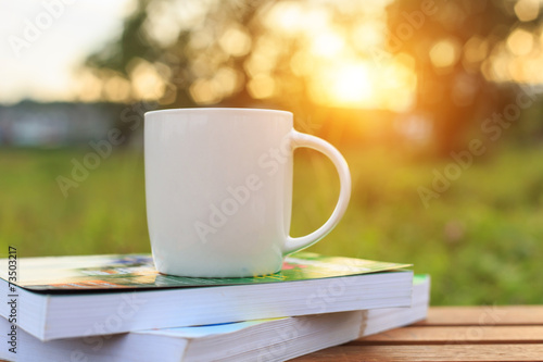 Coffee cup and book on the table in the morning