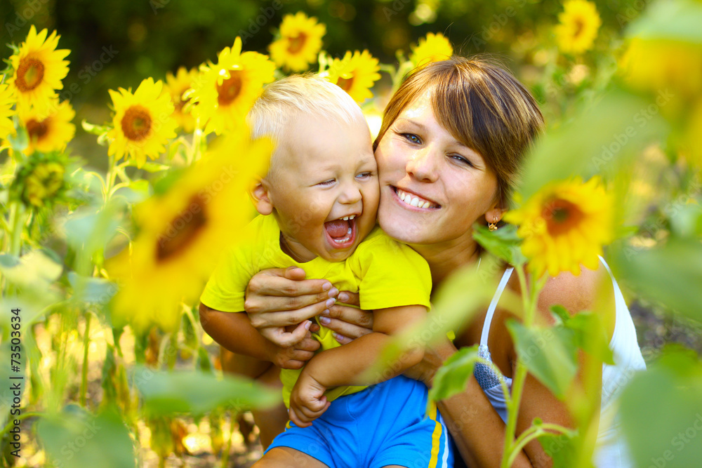 Mom with a little boy in sunflowers Mom with a little boy in sunflowers