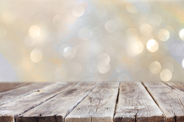 rustic wood table in front of glitter silver and gold bright bok