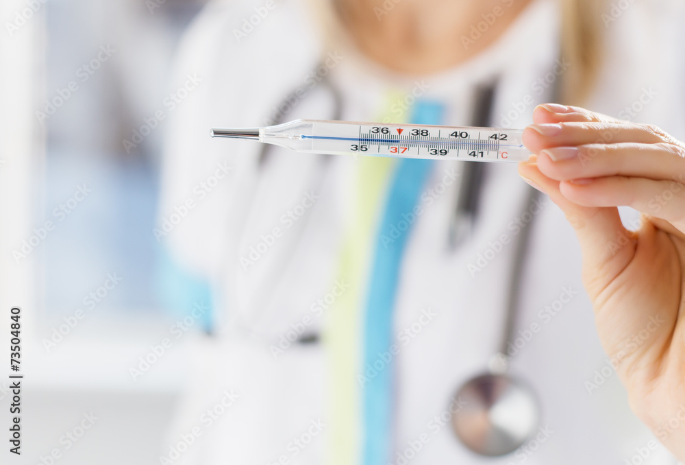 Doctor holding thermometer Doctor holding thermometer