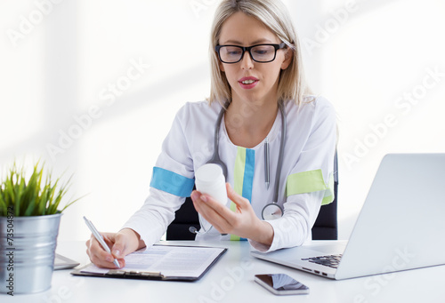 Doctor writing medicine prescription