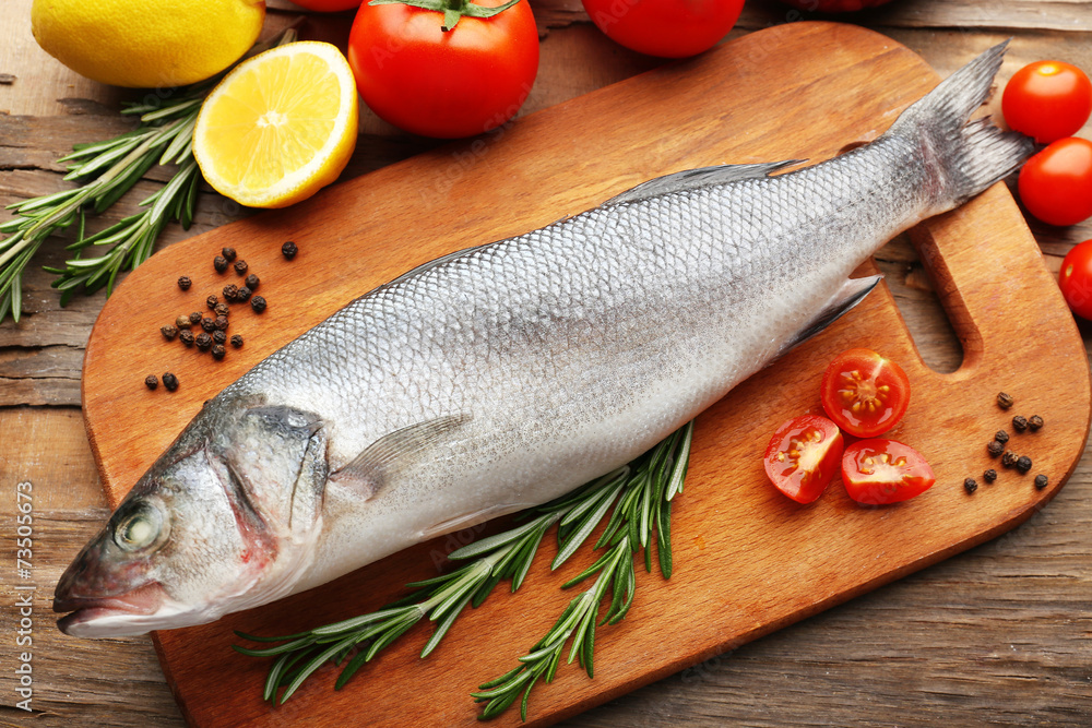 Fresh raw fish and food ingredients on table Fresh raw fish and food ingredients on table