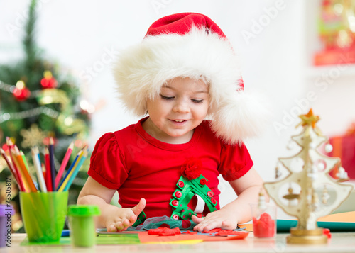 kid in Santa hat making Chr...