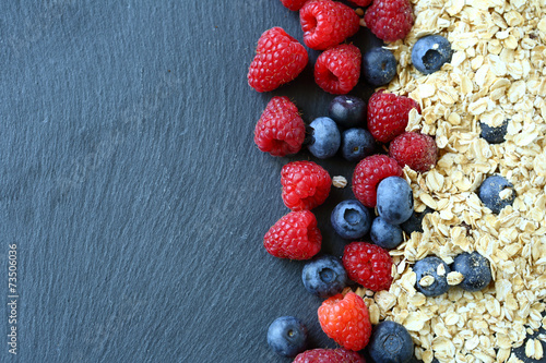 Healthy breakfast and berries on slate background