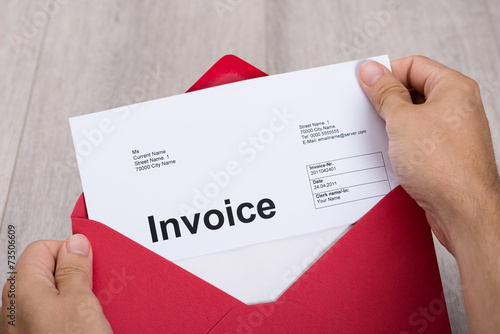 Hand Holding Invoice In Envelope