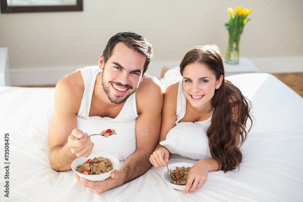 Young couple having breakfast in bed Young couple having breakfast in bed