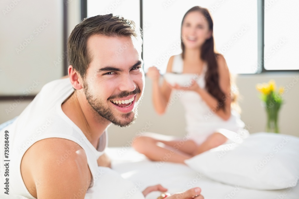 Fototapeta premium Young couple having breakfast in bed