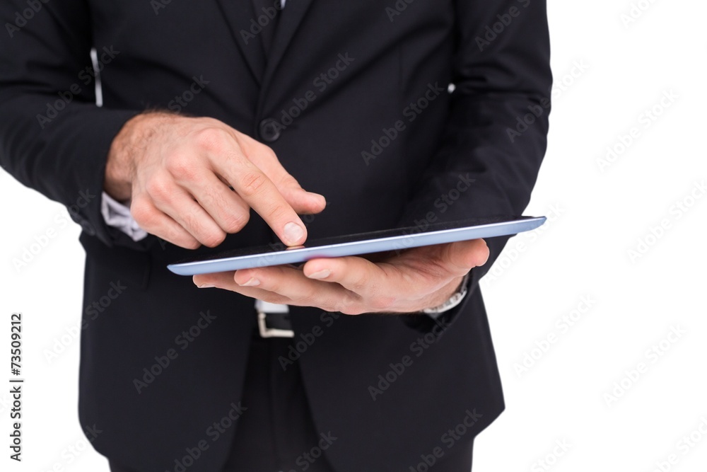 Mid section of a businessman touching digital tablet Mid section of a businessman touching digital tablet