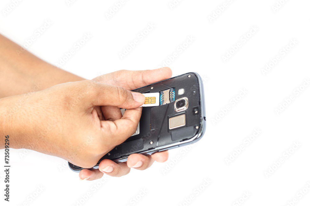 Hand holding sim card and put into smartphone isolated on white Hand holding sim card and put into smartphone isolated on white