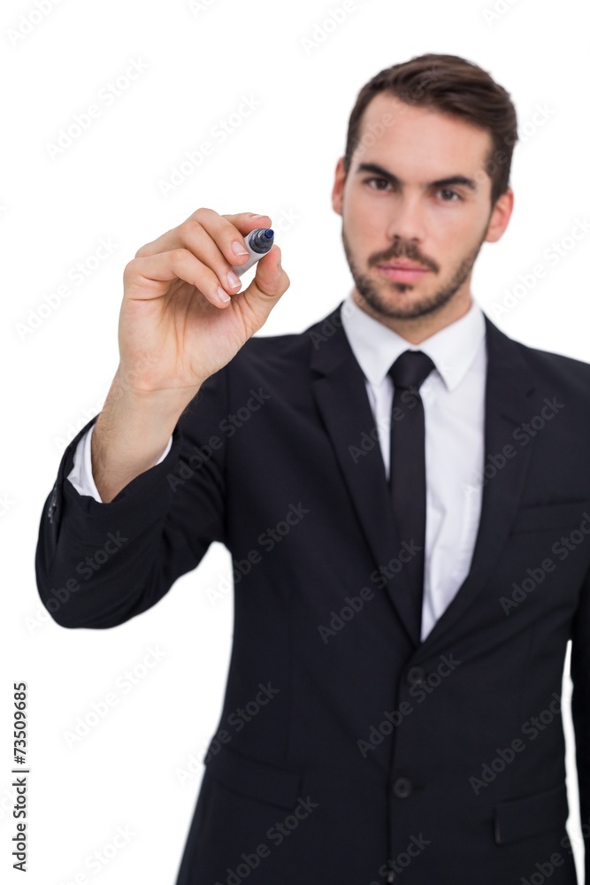 Serious businessman writing with marker Serious businessman writing with marker