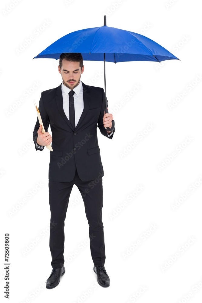 Businessman holding file under a blue umbrella Businessman holding file under a blue umbrella