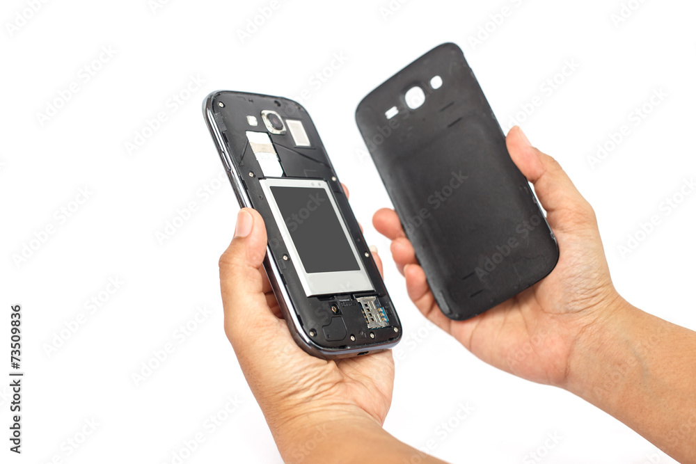 Hand holding smartphone and open backside cover isolated on whit Hand holding smartphone and open backside cover isolated on whit