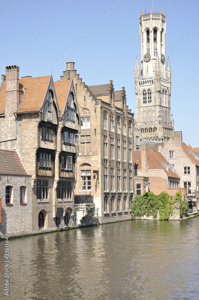 View of the Belfort and one of the canals of Bruges (Belgium)