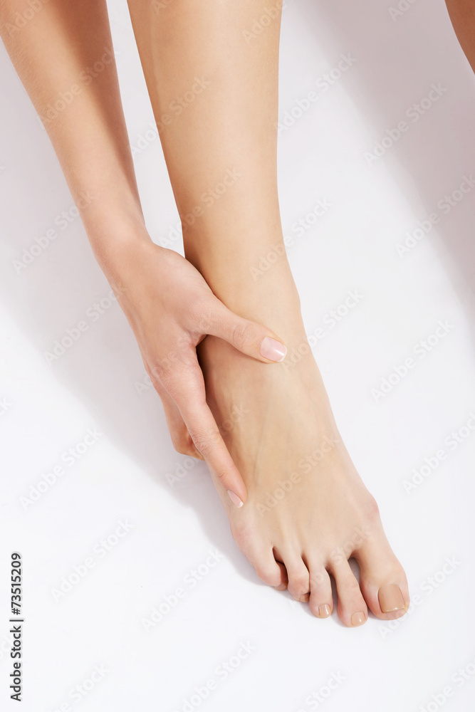 Close up on woman touching her foot bone Close up on woman touching her foot bone