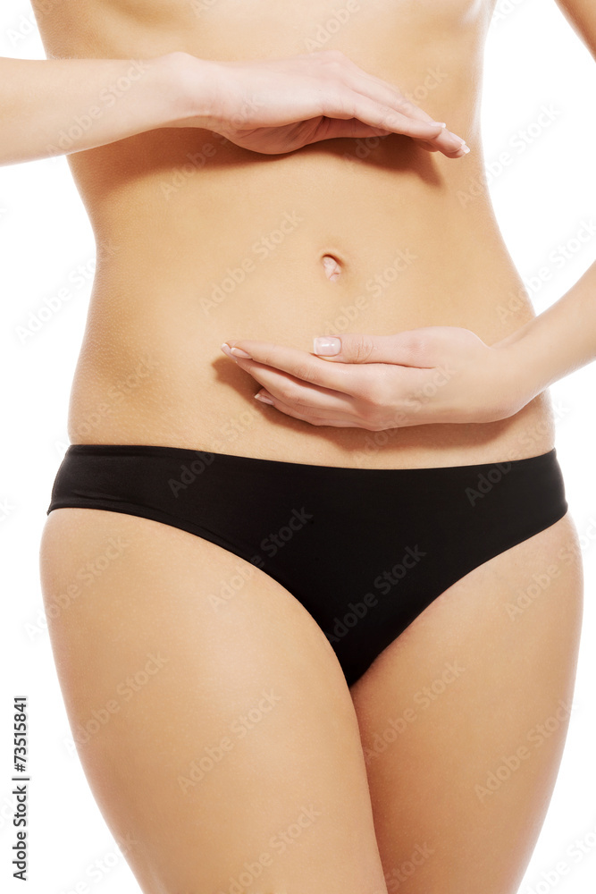 Close up on woman touching her slim belly