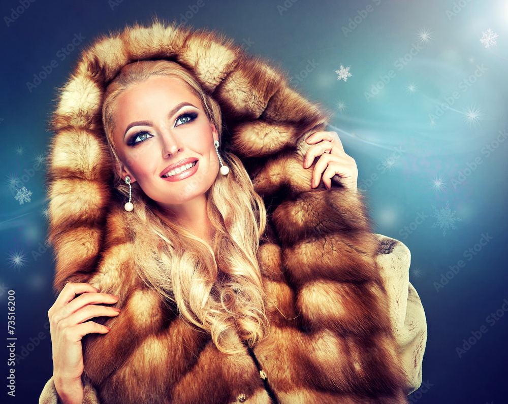 Winter model girl in luxury fur coat with a hood . Winter model girl in luxury fur coat with a hood .