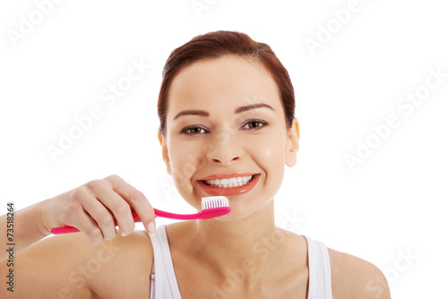 Woman with great teeth holding toothbrush