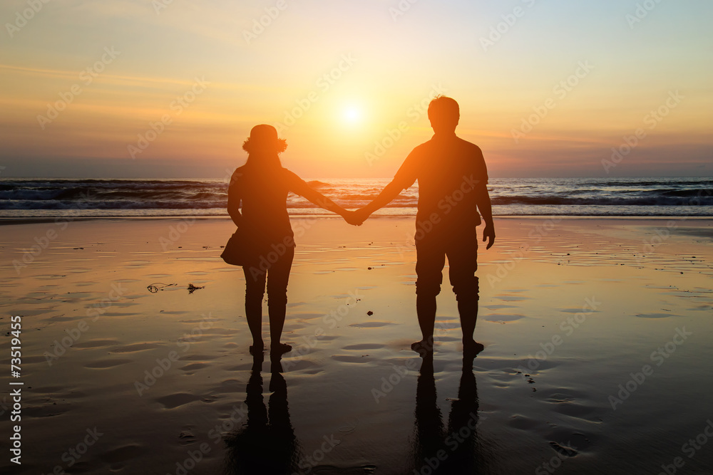 Silhouette of Thai Couple at the beach in sunset time