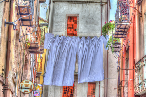 Laundry line with bed sheets in Bosa old town, Sardinia © Gabriele Maltinti