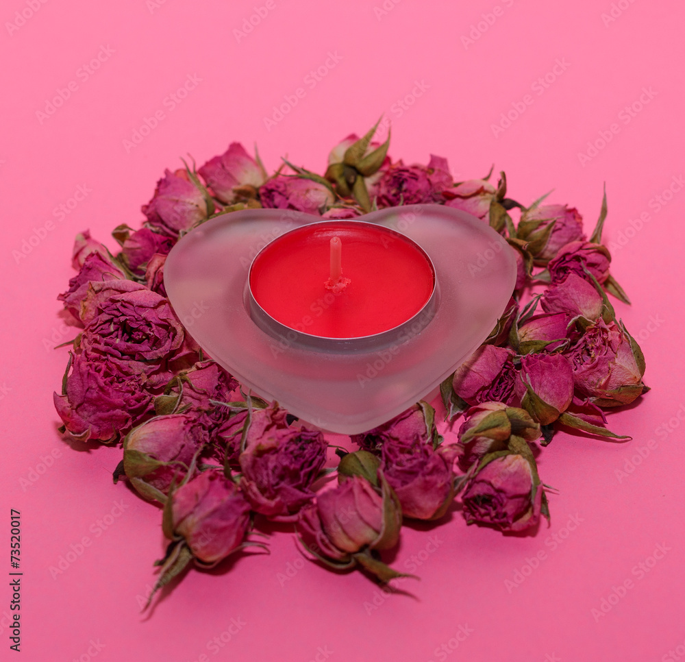 Composition with heart and candle with roses on pink background