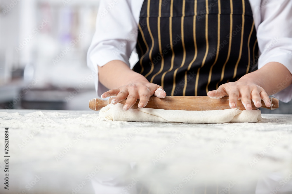 Female Chef Rolling Dough At Messy Counter