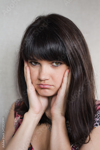 Woman with headache holding head with hands