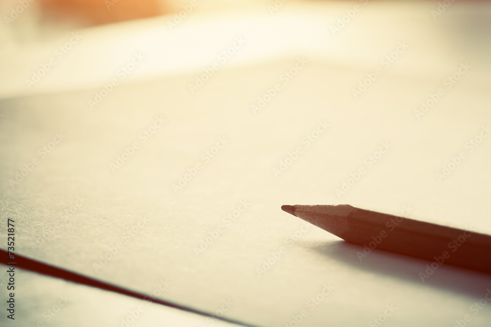 Pencil lying on blank paper in morning light. Pencil lying on blank paper in morning light.