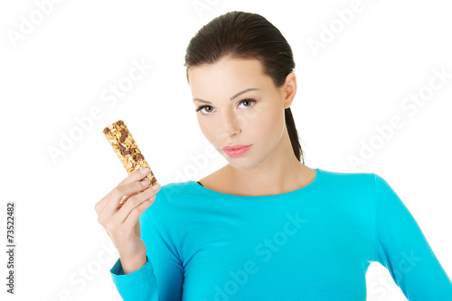 Happy young woman holding grain waffer