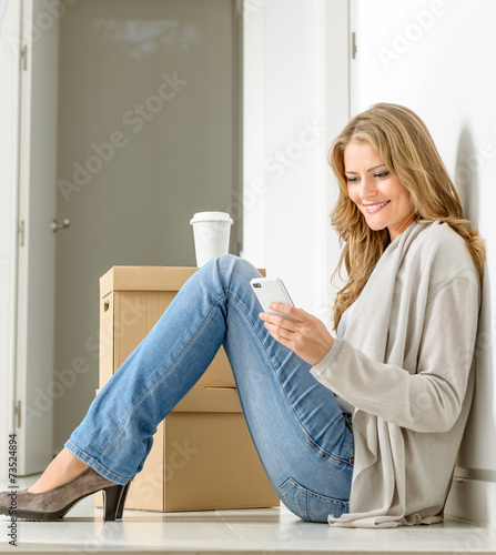 Happy woman texting in new ...