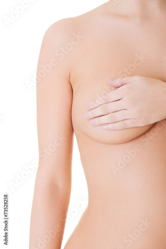 Close up nude woman examining her breast