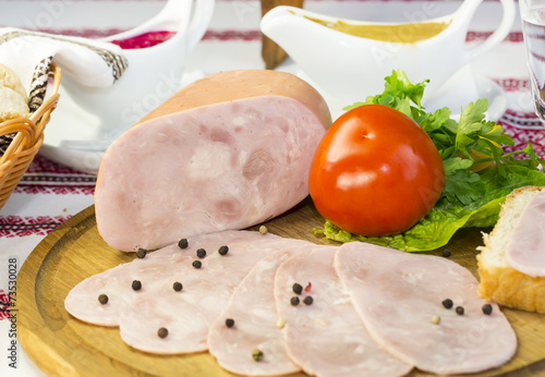 ham on the table in a restaurant with vegetables and sauce
