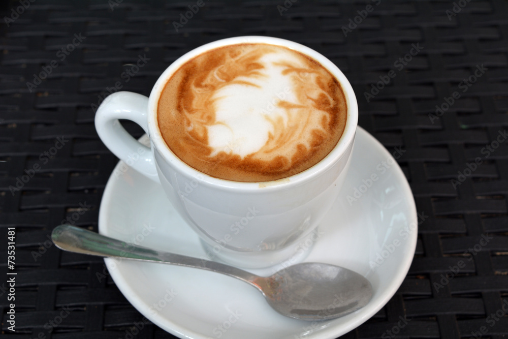 Cup of hot cappuccino on the black background Cup of hot cappuccino on the black background
