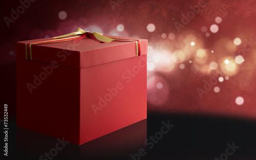 Gift Box over a red and black Christmas background. photo