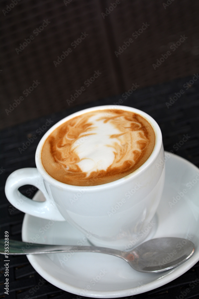 Cup of hot cappuccino on the black background Cup of hot cappuccino on the black background