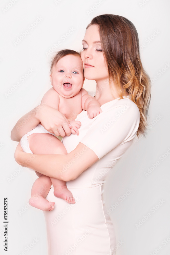 happy mother and baby laughing in the studio happy mother and baby laughing in the studio