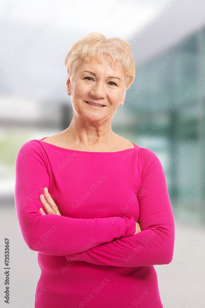 Fototapeta premium Old lady's portrait in pink casual clothes.