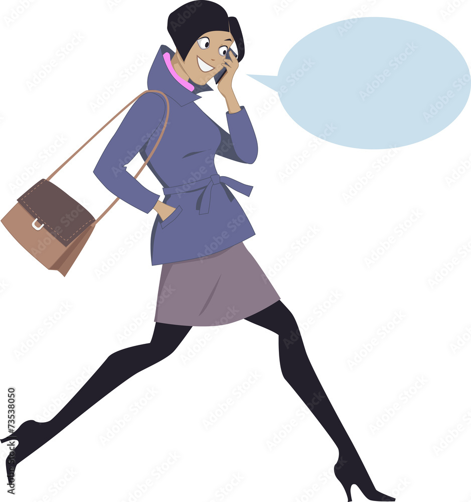 Woman walking and talking on a cell phone Woman walking and talking on a cell phone