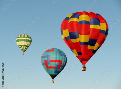 Three hot air balloons in blue sky © Irra