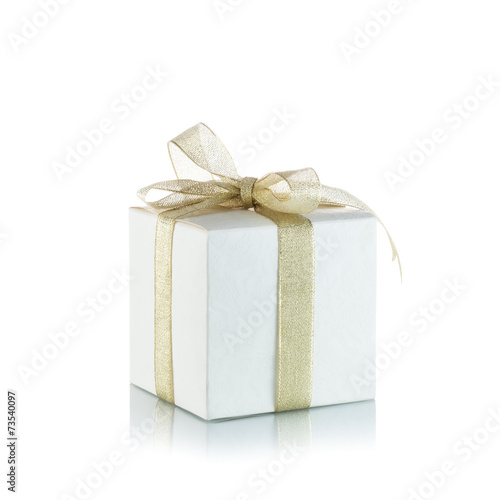 Gift box with golden ribbon bow on white background