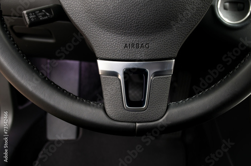 Airbag sign on steering wheel of car. Interior detail. photo