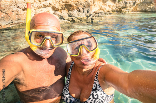 Senior happy couple taking a selfie at Blue Lagoon in Malta