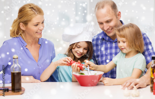 happy family with two kids making salad at home