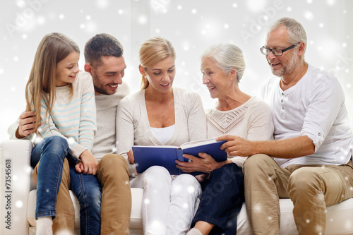 happy family with book or photo album at home