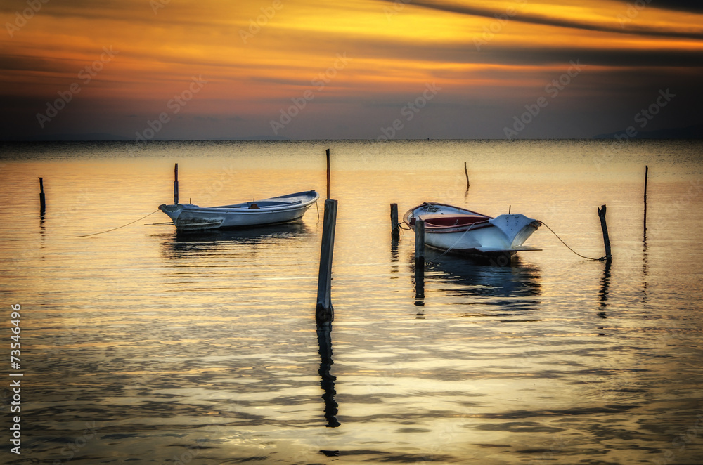 Peaceful sunset with lonely boats