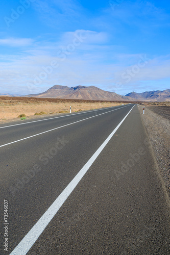 Road in desert landscape with mountains, Fuerteventura island